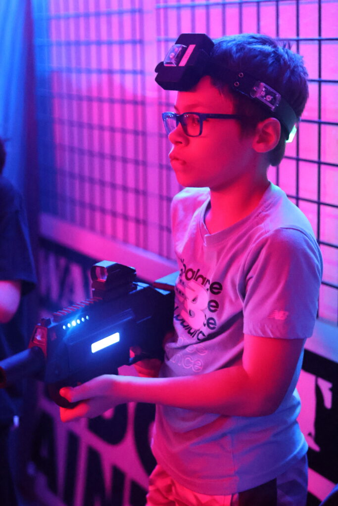 A boy playing laser tag at Extreme Velocity.